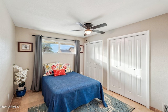 bedroom with two closets and ceiling fan