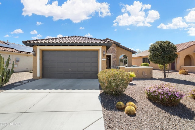 view of front of home with stone siding, stucco siding, an attached garage, and concrete driveway