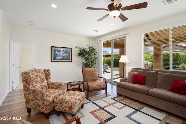 living room with recessed lighting, visible vents, and light wood-style flooring