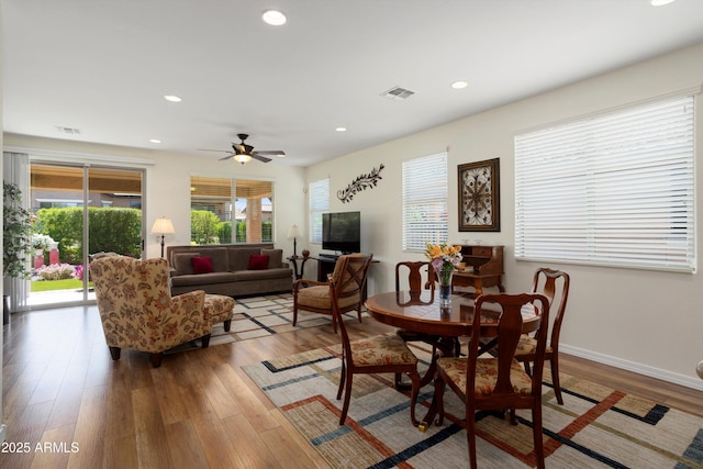 living room with visible vents, recessed lighting, and wood finished floors