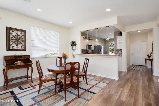 dining area featuring visible vents, recessed lighting, light wood-type flooring, and baseboards