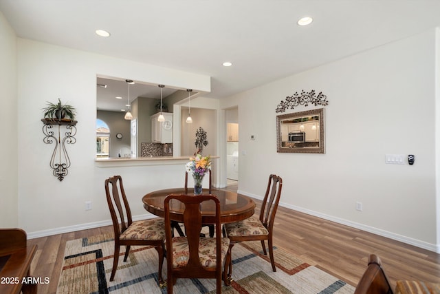 dining space featuring recessed lighting, baseboards, and wood finished floors