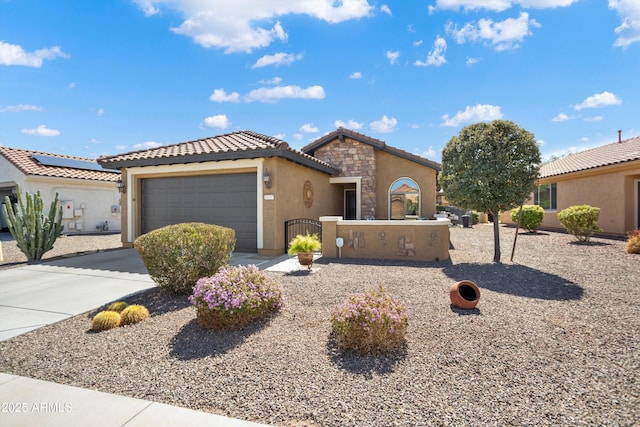 view of front of house with driveway, a garage, a fenced front yard, stone siding, and a tile roof