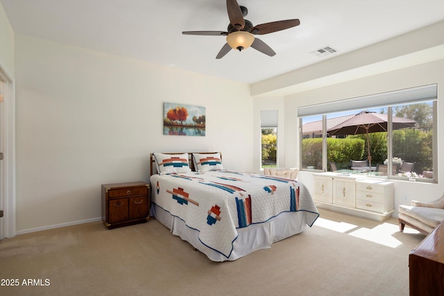 bedroom featuring baseboards, a ceiling fan, visible vents, and light carpet