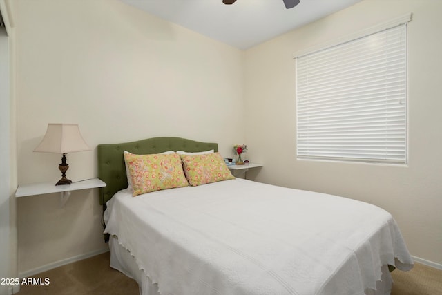 bedroom with ceiling fan, baseboards, carpet, and multiple windows