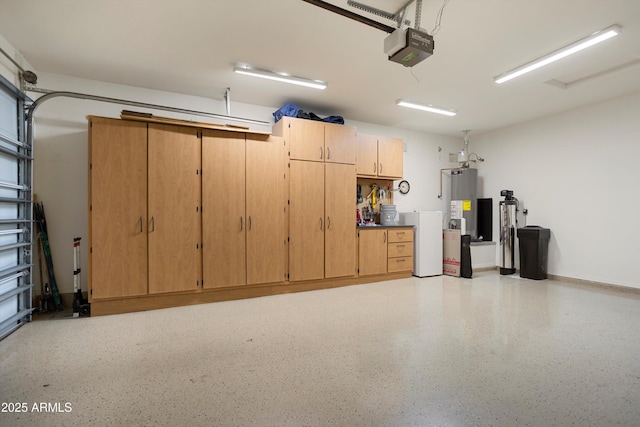 garage featuring a garage door opener and water heater