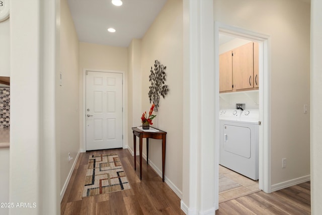 hall with recessed lighting, independent washer and dryer, light wood finished floors, and baseboards