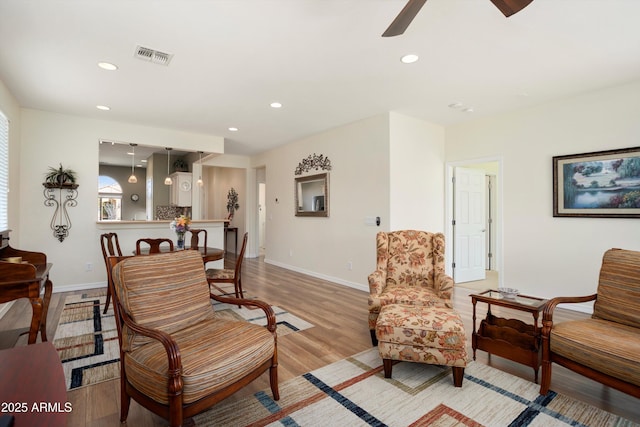 living area with recessed lighting, visible vents, baseboards, and light wood-style flooring