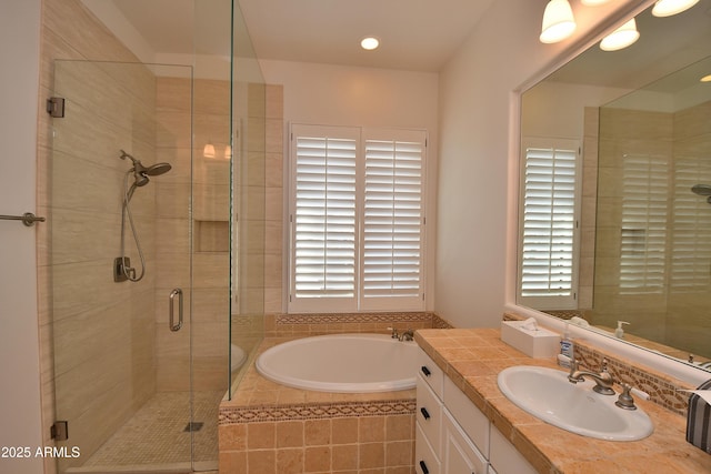 bathroom featuring plenty of natural light, vanity, and separate shower and tub