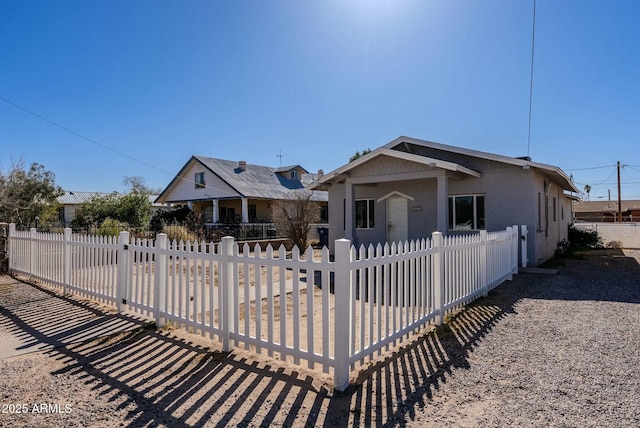bungalow-style home featuring a fenced front yard