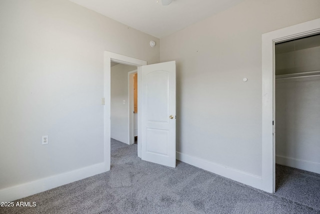 unfurnished bedroom featuring baseboards, a closet, and carpet floors