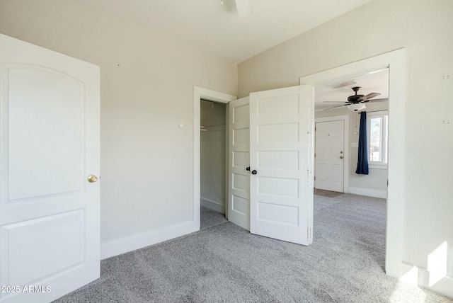 unfurnished bedroom with a closet, baseboards, and carpet floors