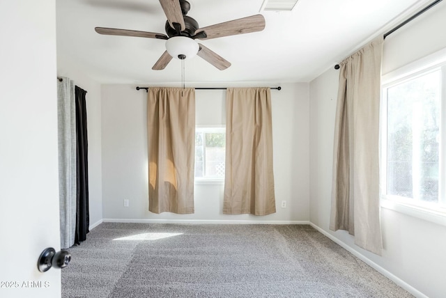 spare room with carpet flooring, baseboards, and a ceiling fan