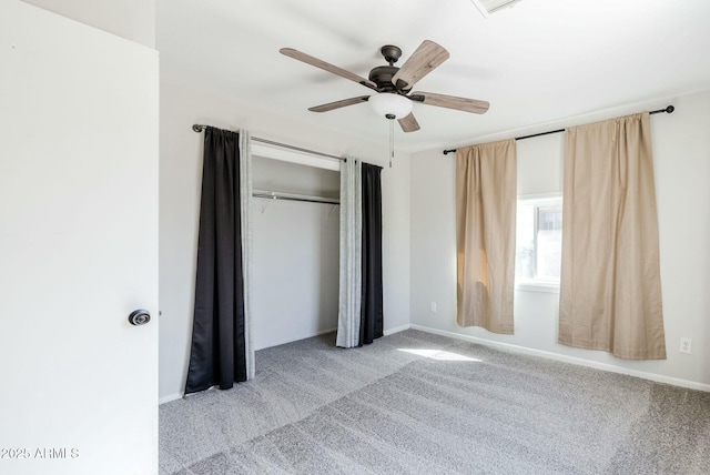 unfurnished bedroom featuring carpet flooring, a ceiling fan, a closet, and baseboards