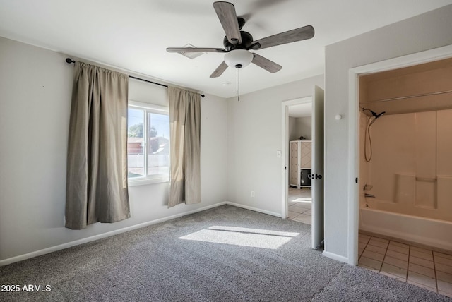 unfurnished bedroom with tile patterned floors, a ceiling fan, baseboards, and carpet floors