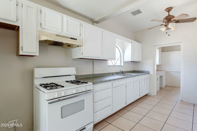kitchen featuring visible vents, under cabinet range hood, white range with gas stovetop, light tile patterned floors, and a ceiling fan