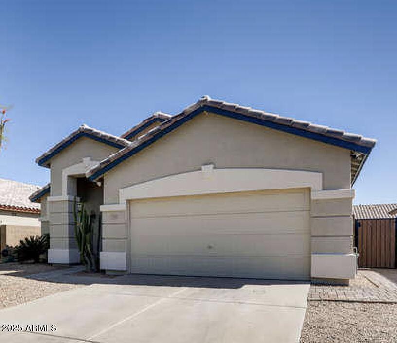 3905 E Kristal Way, Phoenix, AZ 85050 - ranch-style home featuring driveway, a garage, stucco siding, and a tiled roof