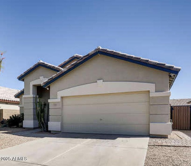 3905 E Kristal Way, Phoenix, AZ 85050 - ranch-style home featuring driveway, a garage, stucco siding, and a tiled roof