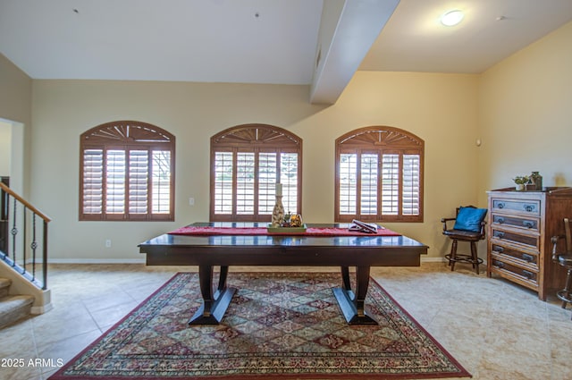 recreation room featuring light tile patterned floors, baseboards, and plenty of natural light