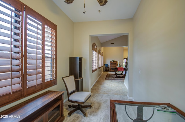 sitting room with carpet flooring, baseboards, and lofted ceiling