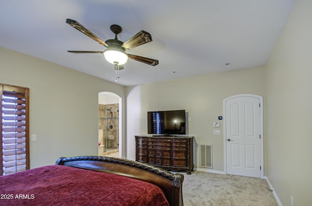 bedroom with visible vents, arched walkways, carpet flooring, baseboards, and ceiling fan