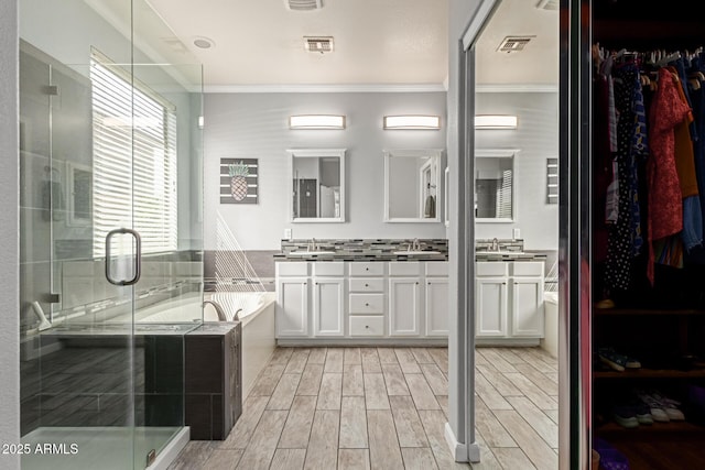 9225 W Clara Ln, Peoria, AZ 85382 - full bath with double vanity, wood finish floors, a shower stall, visible vents, and a garden tub