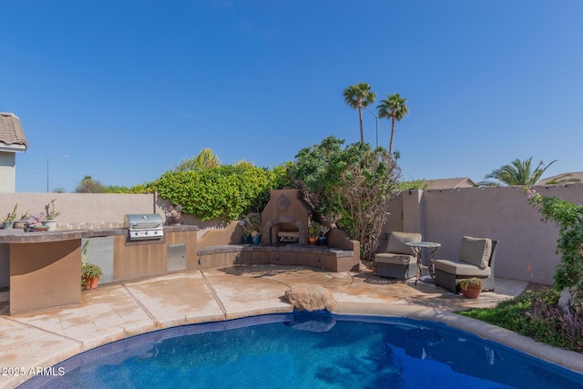 9225 W Clara Ln, Peoria, AZ 85382 - view of swimming pool with fence, an outdoor fireplace, exterior kitchen, and a patio