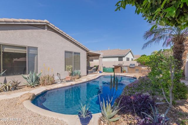 9225 W Clara Ln, Peoria, AZ 85382 - view of swimming pool featuring a patio area, fence, a fenced in pool, and an outdoor kitchen
