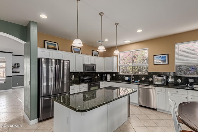9225 W Clara Ln, Peoria, AZ 85382 - kitchen featuring tasteful backsplash, light tile patterned floors, white cabinets, appliances with stainless steel finishes, and a sink