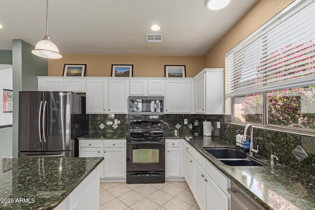 9225 W Clara Ln, Peoria, AZ 85382 - kitchen featuring appliances with stainless steel finishes, white cabinets, visible vents, decorative backsplash, and a sink