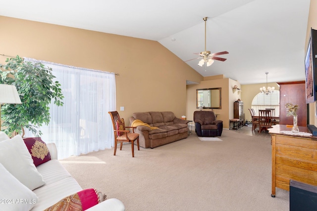 living room with ceiling fan with notable chandelier, light colored carpet, and plenty of natural light