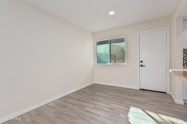 empty room with light hardwood / wood-style floors