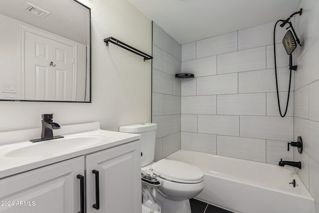 full bathroom with tile patterned floors, toilet, vanity, and tiled shower / bath