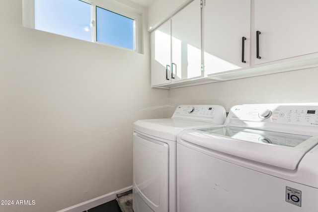 washroom featuring cabinets and washer and dryer