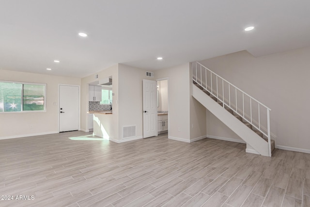 unfurnished living room featuring light wood-type flooring