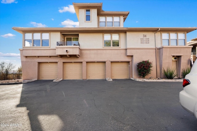 view of front facade featuring a balcony and a garage