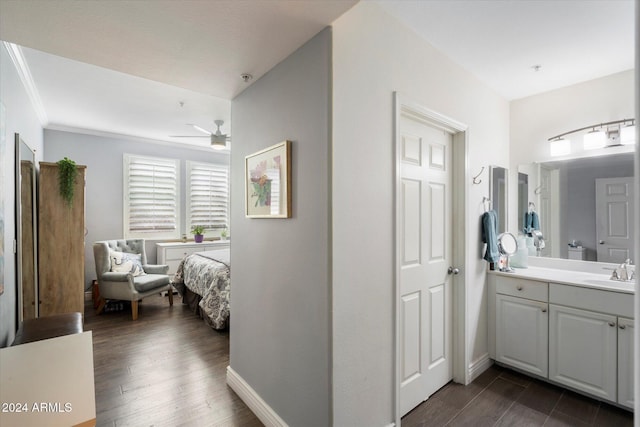 bathroom featuring ceiling fan, vanity, wood-type flooring, and ornamental molding