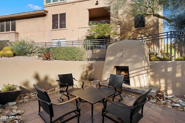 view of patio / terrace featuring an outdoor fireplace