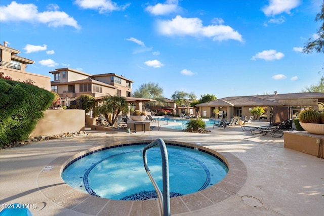 view of pool with a community hot tub and a patio