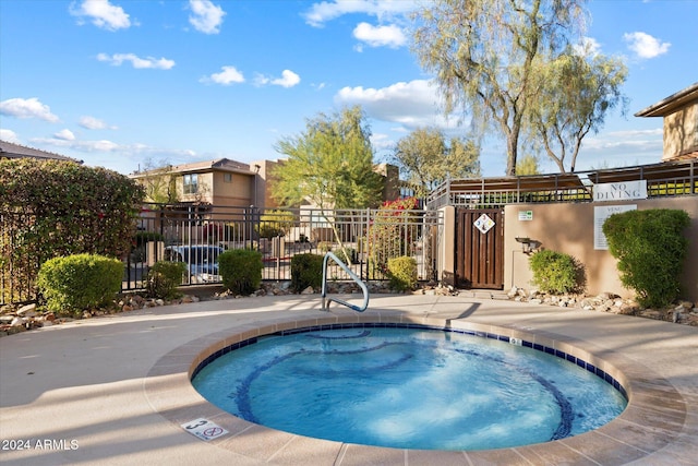 view of swimming pool featuring a community hot tub