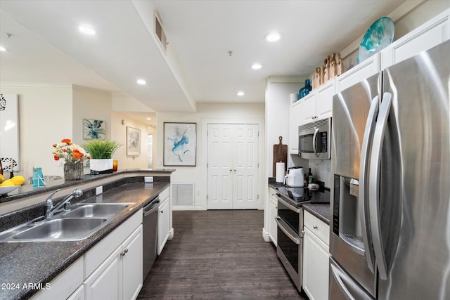 kitchen featuring stainless steel appliances, crown molding, sink, white cabinets, and dark hardwood / wood-style floors