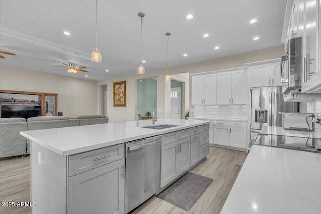 28319 N Marchant Trce, Queen Creek, AZ 85144 - kitchen featuring an island with sink, light countertops, a sink, and stainless steel appliances