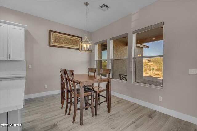 28319 N Marchant Trce, Queen Creek, AZ 85144 - dining space featuring light wood-style flooring, a notable chandelier, baseboards, and visible vents