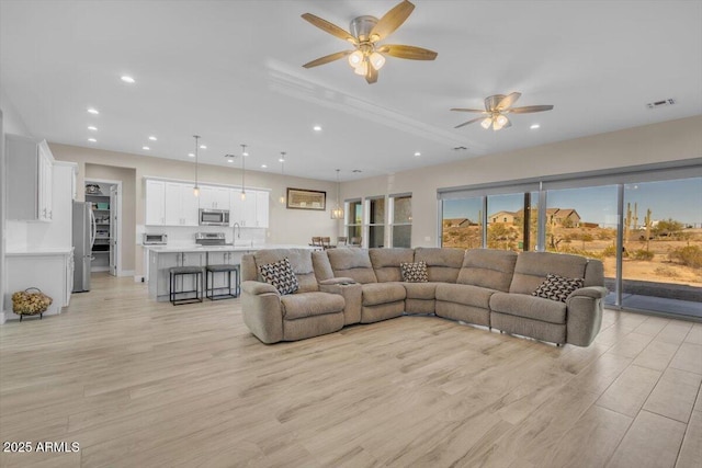 28319 N Marchant Trce, Queen Creek, AZ 85144 - living area featuring light wood-style flooring, ceiling fan, visible vents, and recessed lighting