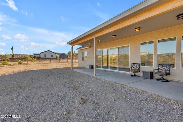 28319 N Marchant Trce, Queen Creek, AZ 85144 - rear view of house featuring fence, stucco siding, and a patio