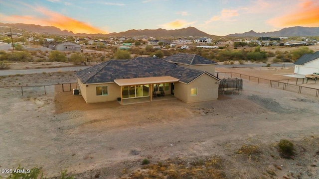 28319 N Marchant Trce, Queen Creek, AZ 85144 - back of house featuring central air condition unit, stucco siding, fence, and a mountain view