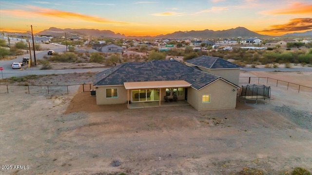 28319 N Marchant Trce, Queen Creek, AZ 85144 - view of front facade with stucco siding, fence, and a trampoline