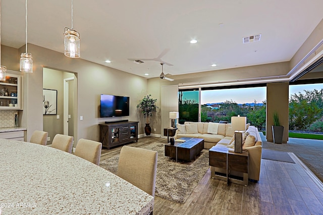 living room with hardwood / wood-style flooring and ceiling fan