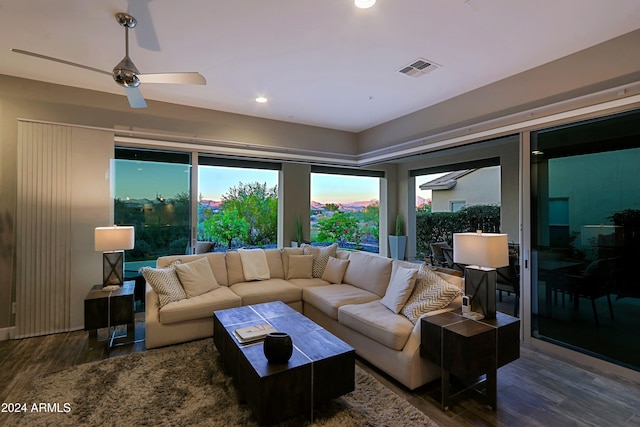 living room featuring dark hardwood / wood-style flooring and ceiling fan