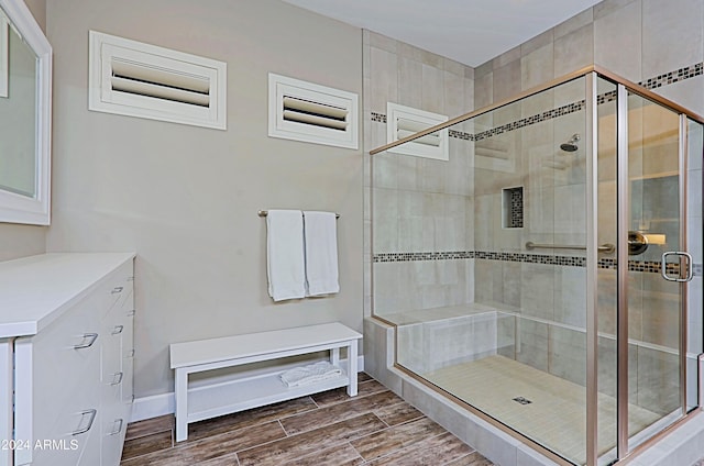 bathroom with a shower with door